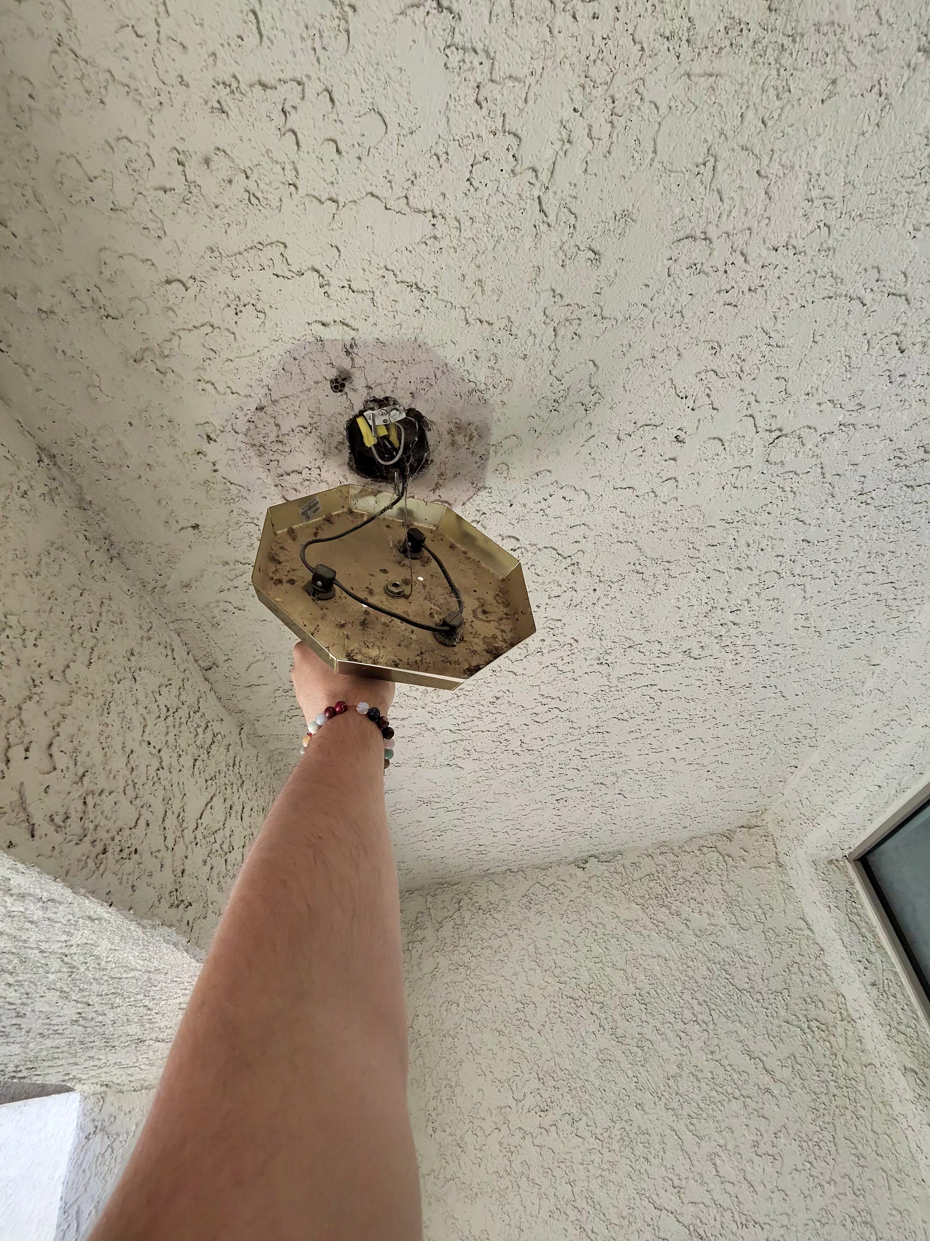 Fixture removed with wiring visible