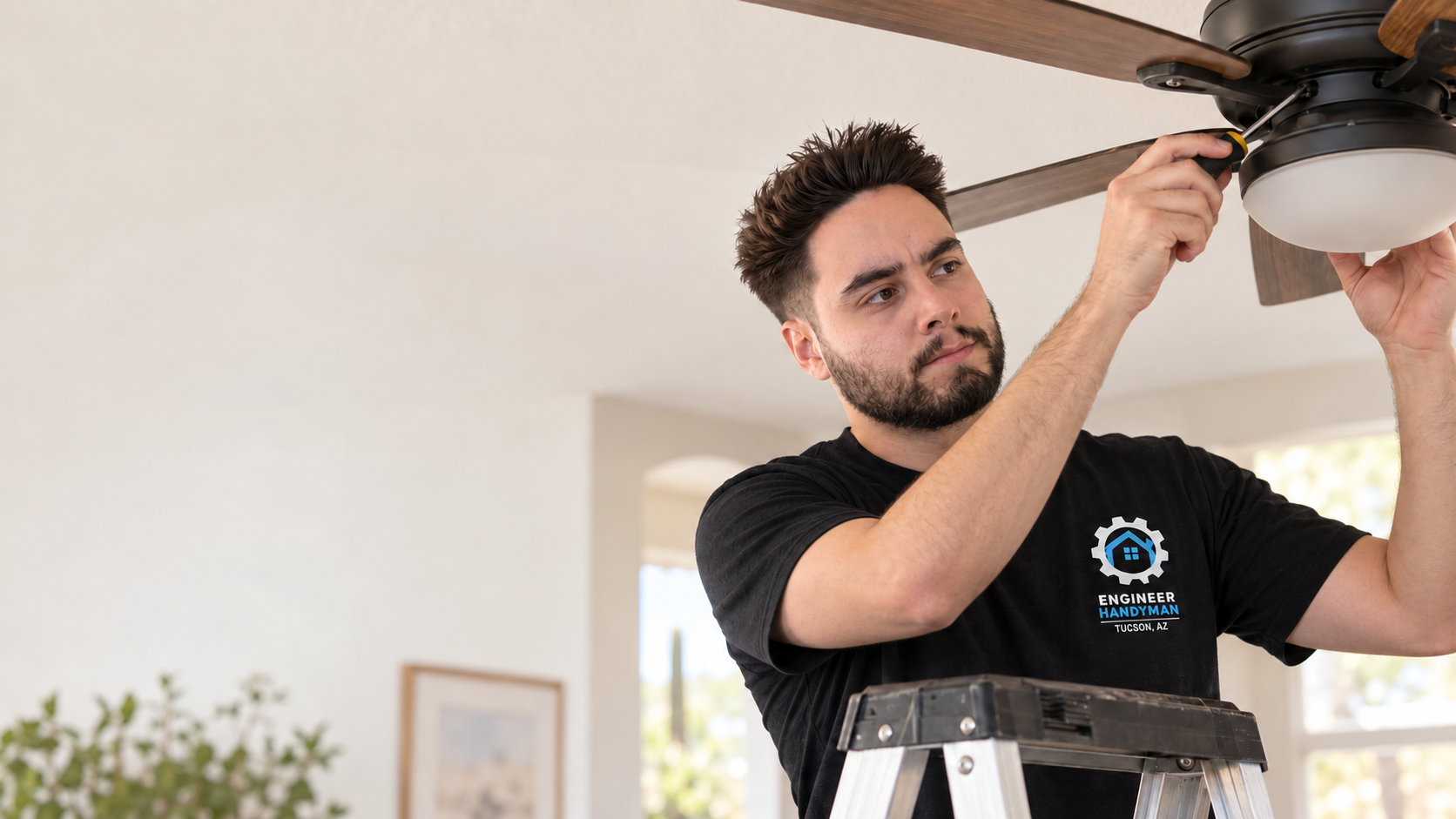 Luis installing a ceiling fan in a Tucson home