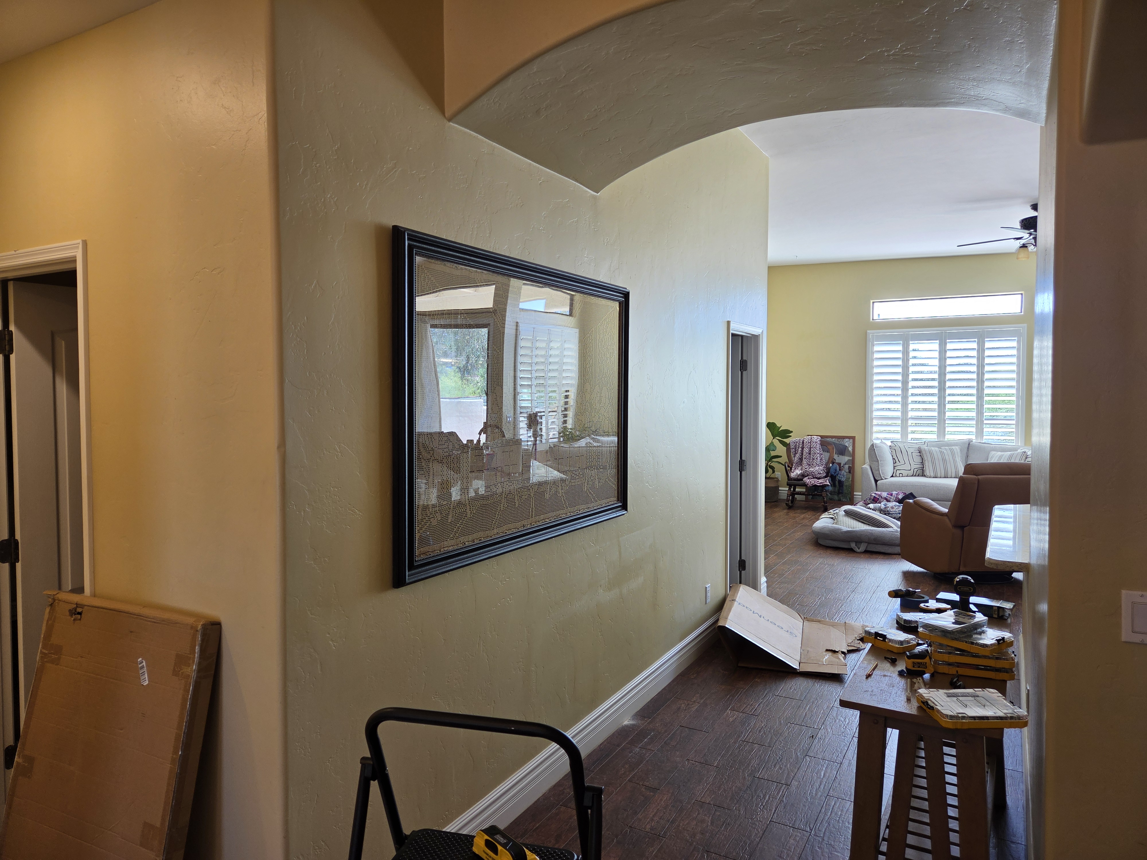 Large framed wall art mounted in hallway