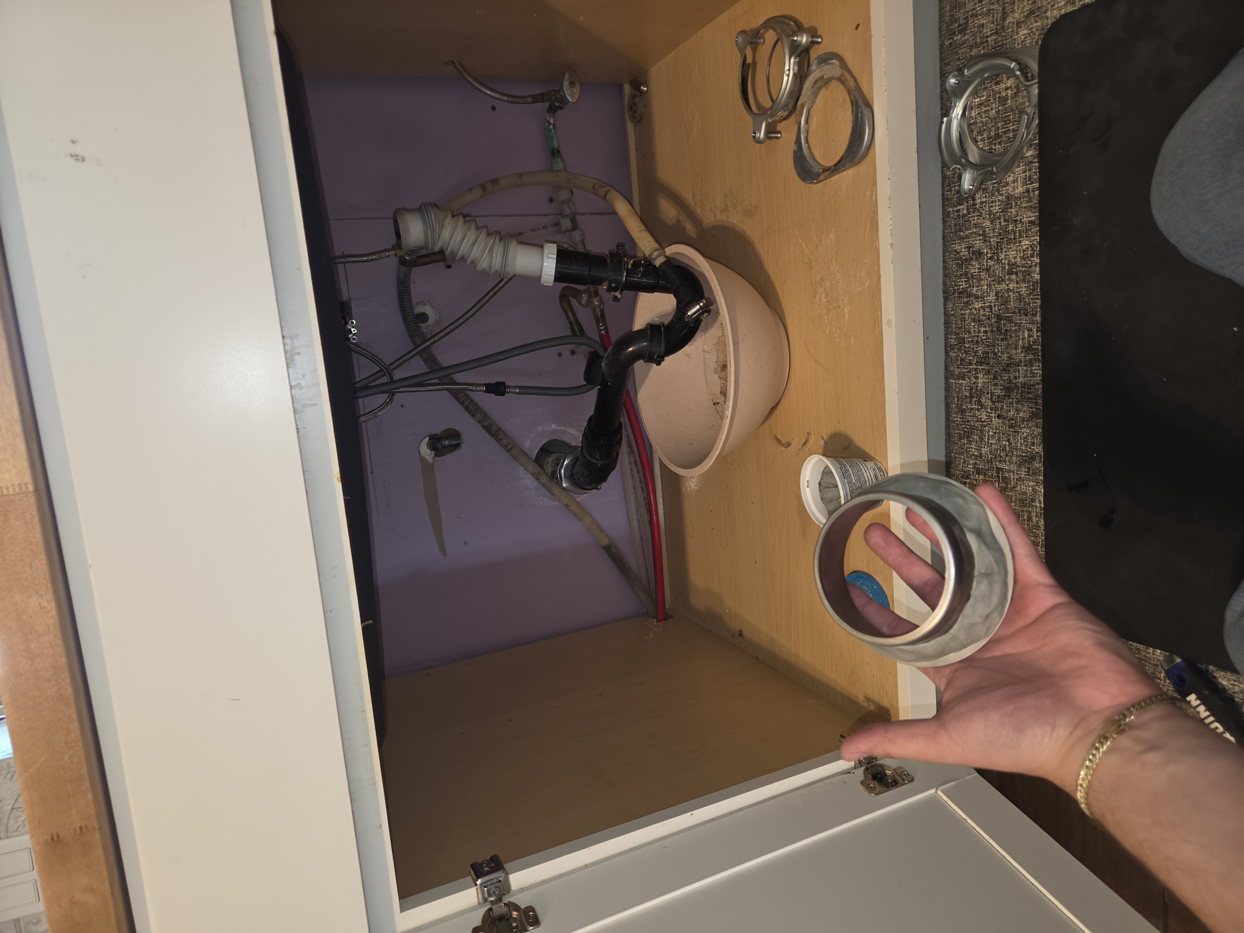 New garbage disposal unit staged during installation